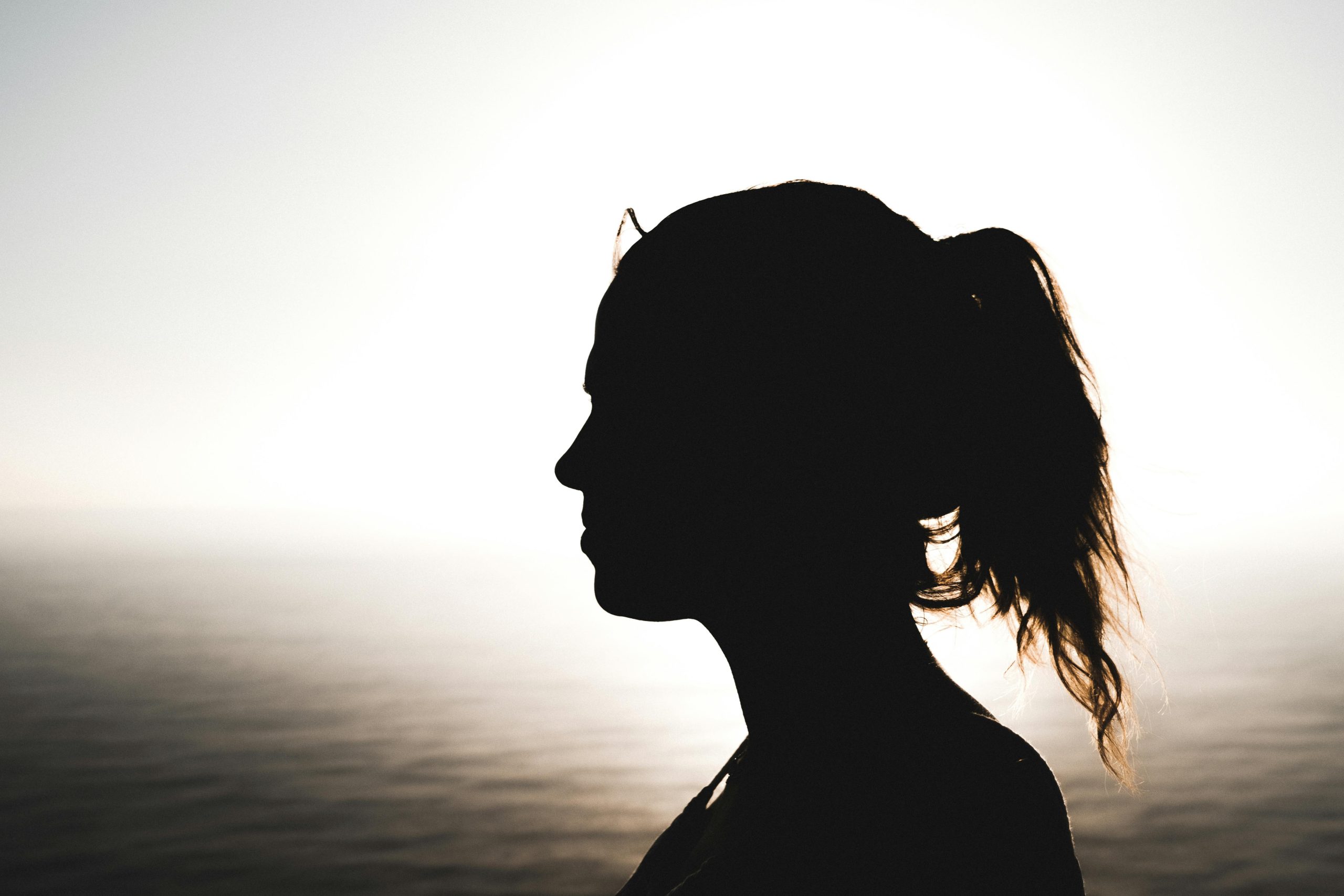 silhouette of woman looking at horizon
